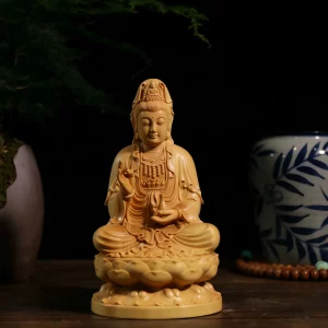 Front view of a boxwood Guanyin seated on a lotus pedestal with a slender water vase