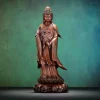 Standing copper Guanyin holding a willow and a downturned vase, with flowing robes and an ornate lotus pedestal