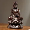 Front view of dark wood Guanyin holding a vase above a layered lotus throne