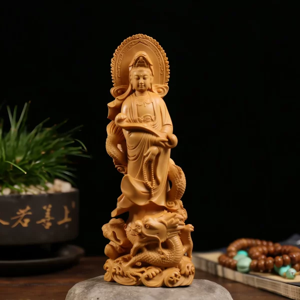 Front view of a warm golden boxwood Dragon Guanyin statue holding a ruyi scepter above a coiled dragon and waves