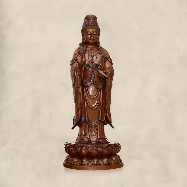 Front of a large standing copper Guanyin with a willow branch, tilted water vase and double lotus base