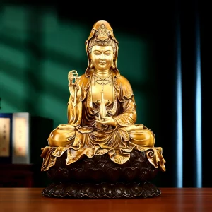Front view of Nanhai Guanyin in gold-toned brass with a willow sprig, slender vase and dark lotus pedestal