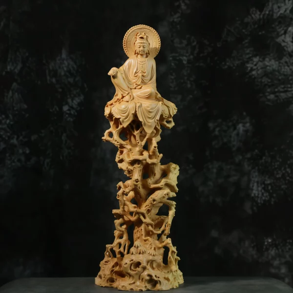 Front view of a boxwood Guanyin in royal ease above a tall openwork rock formation