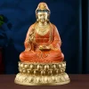 Front view of the 37.8 cm painted brass Guanyin statue, with red robes and a gold-colored lotus pedestal