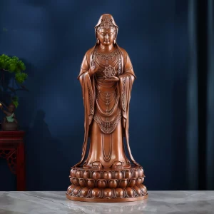 Front view of the 47.5 cm copper Putuo Guanyin, holding a Dharma wheel above a layered lotus pedestal