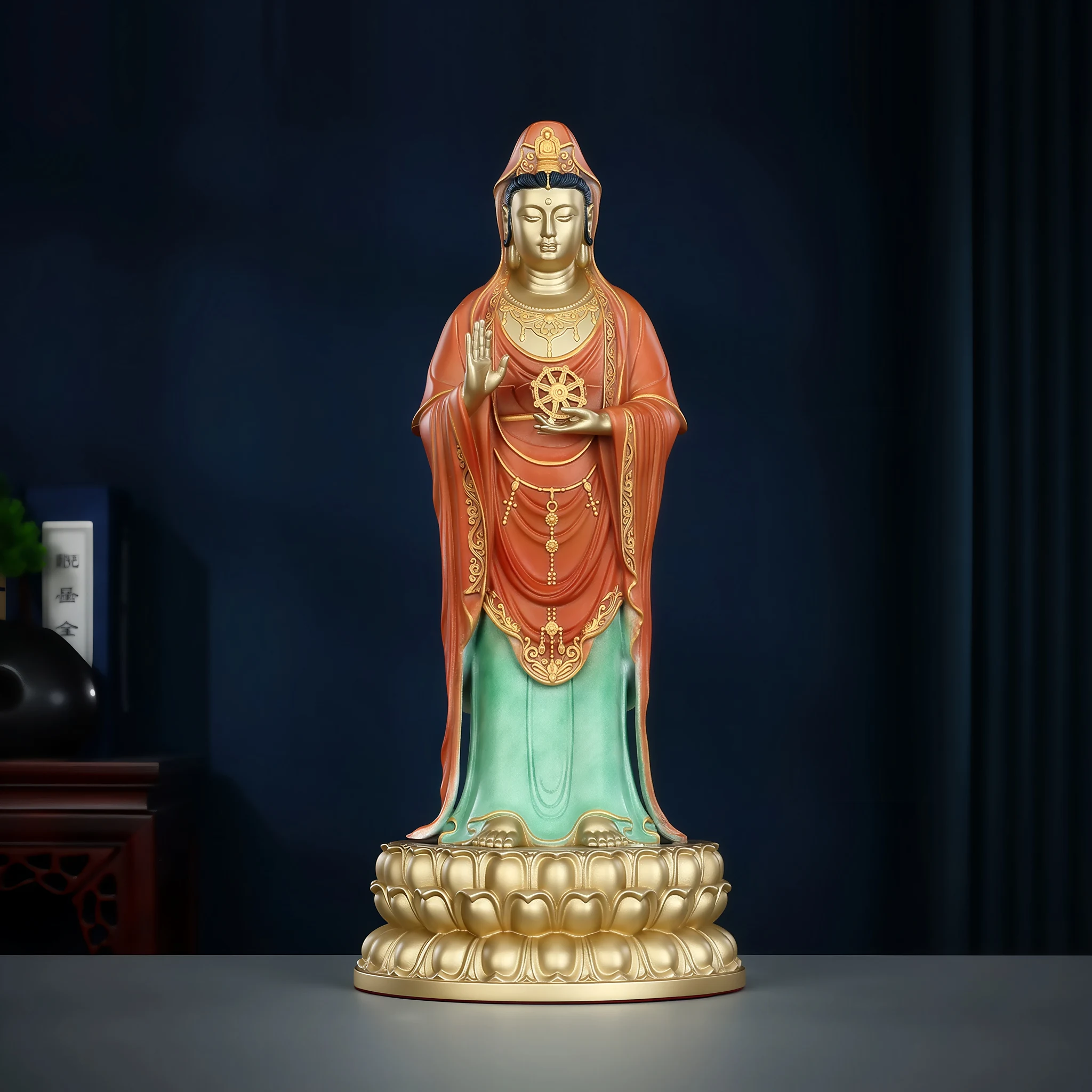 Standing Putuo Guanyin in red and green robes, holding a Dharma wheel above a gold-tone lotus base, 38 cm