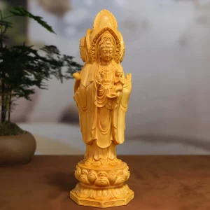 Front view of the three-sided wooden Guanyin holding a child above a lotus pedestal