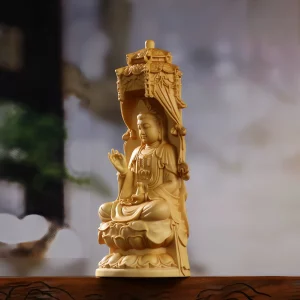 Side view of Daita Kuan Yin showing the raised hand, water vase and carved canopy Side view of Daita Kuan Yin showing the raised hand, water vase and carved canopy