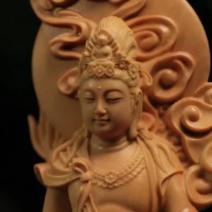 Lowered eyes, crown and curling clouds of the boxwood dragon-riding Guanyin Lowered eyes, crown and curling clouds of the boxwood dragon-riding Guanyin