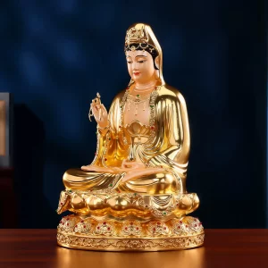 Golden Yangliu Kuan Yin — Three-Quarter View Angled view of gilded brass Yangliu Kuan Yin showing reflective robe folds, the slender vase and red and green ornamental accents