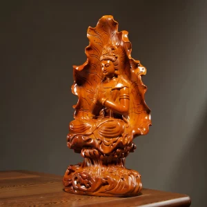 Lotus Leaf Guanyin — Three-quarter view — left Left three-quarter view of Hezhang Kuan Yin showing the joined hands, folded robes and carved pedestal