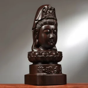 Three-quarter view of the Kuan Yin head sculpture, showing the draped headdress and lotus base Three-quarter view of the Kuan Yin head sculpture, showing the draped headdress and lotus base
