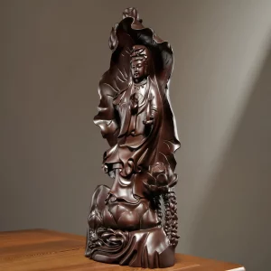Lianye Kuan Yin — Left Three-quarter View Left three-quarter view of the wooden Kuan Yin against a broad lotus leaf