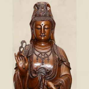 Standing Kuan Yin — Face and Crown Close view of standing Kuan Yin’s lowered eyes, small Buddha in the crown, necklace and patterned copper robe borders