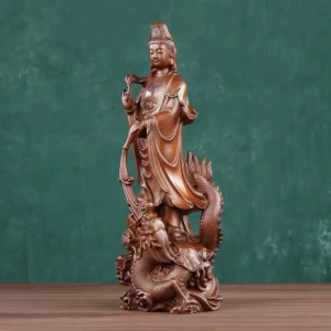 Three-quarter view of Xianglong Guanyin with long robes above the raised head of a dragon Three-quarter view of Xianglong Guanyin with long robes above the raised head of a dragon