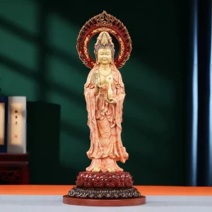 Yangzhi Guanyin in coral and gold, holding a willow sprig and water vase beneath a red flame-shaped halo Yangzhi Guanyin in coral and gold, holding a willow sprig and water vase beneath a red flame-shaped halo