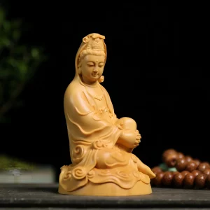 Guanyin at Ease — Three-quarter view Three-quarter view of Zizai Kuan Yin showing the raised knee, visible foot and curled robe edges