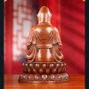 Back of the seated copper Guanyin with a smooth hood, draped robe and layered lotus base