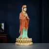 Side view of the 38 cm painted brass Guanyin showing the layered red robe and standing posture