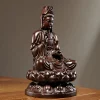 Side view of the wooden Kuan Yin, showing the vase, robe folds and lotus seat