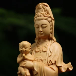 Songzi Guanyin — Face and Child Detail Guanyin’s lowered eyes and crown above the smiling child in her arms