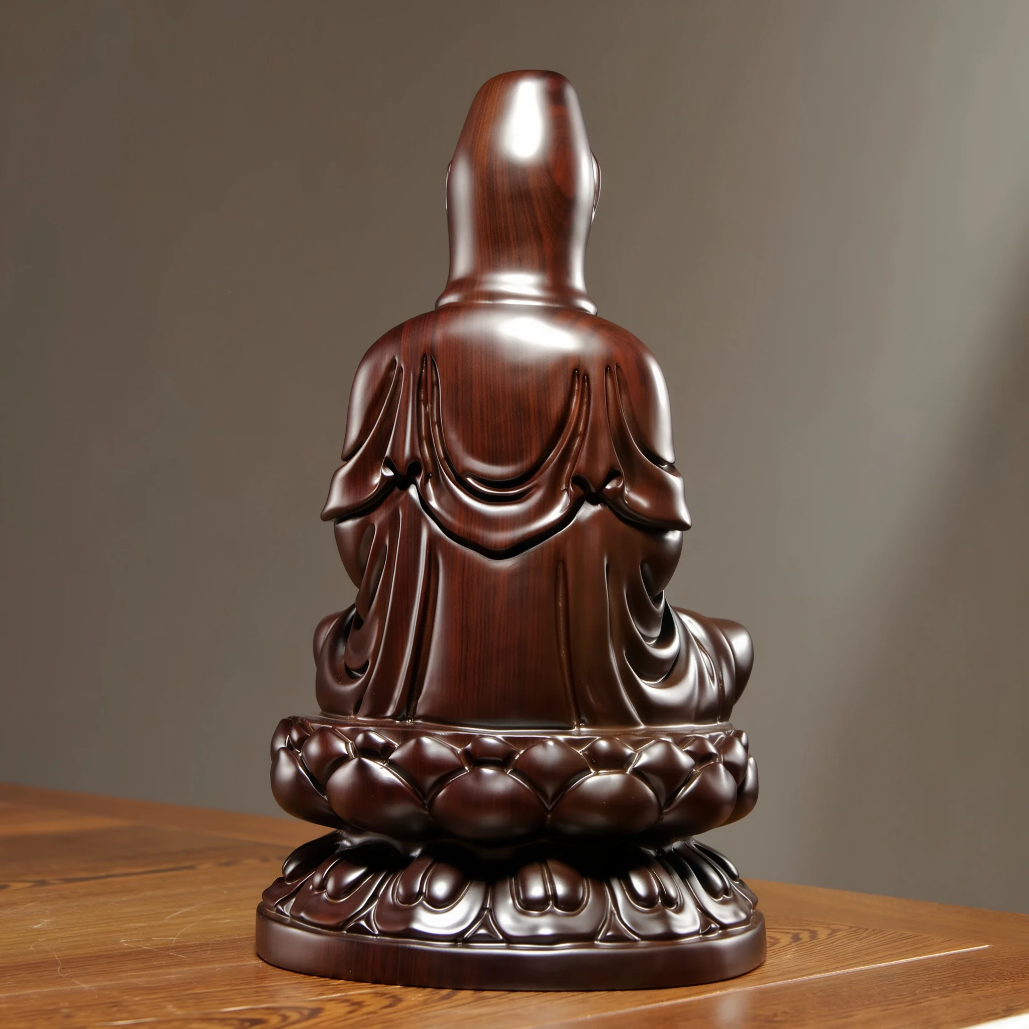 Back view of the Guanyin carving, with dark wood grain and flowing robe folds