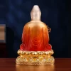 Back of the 39 cm brass Guanyin with orange-to-red robe folds, a pale head veil and rounded lotus petals above the decorated base