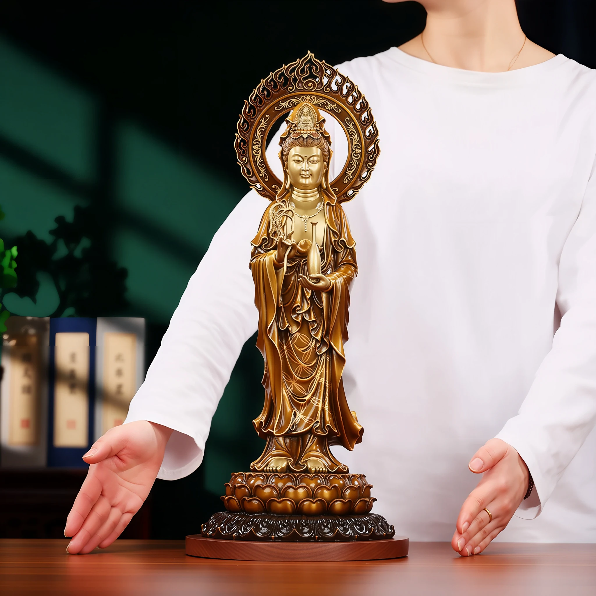 Standing brass Guanyin displayed beside a person’s hands for a sense of its 45 cm scale