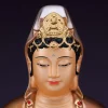Close view of the 39 cm Guanyin’s painted eyes, red lips, white veil and small Buddha figure in the crown