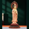 Side view of the coral and gold Yangzhi Guanyin with a flame halo, layered robes and lotus base