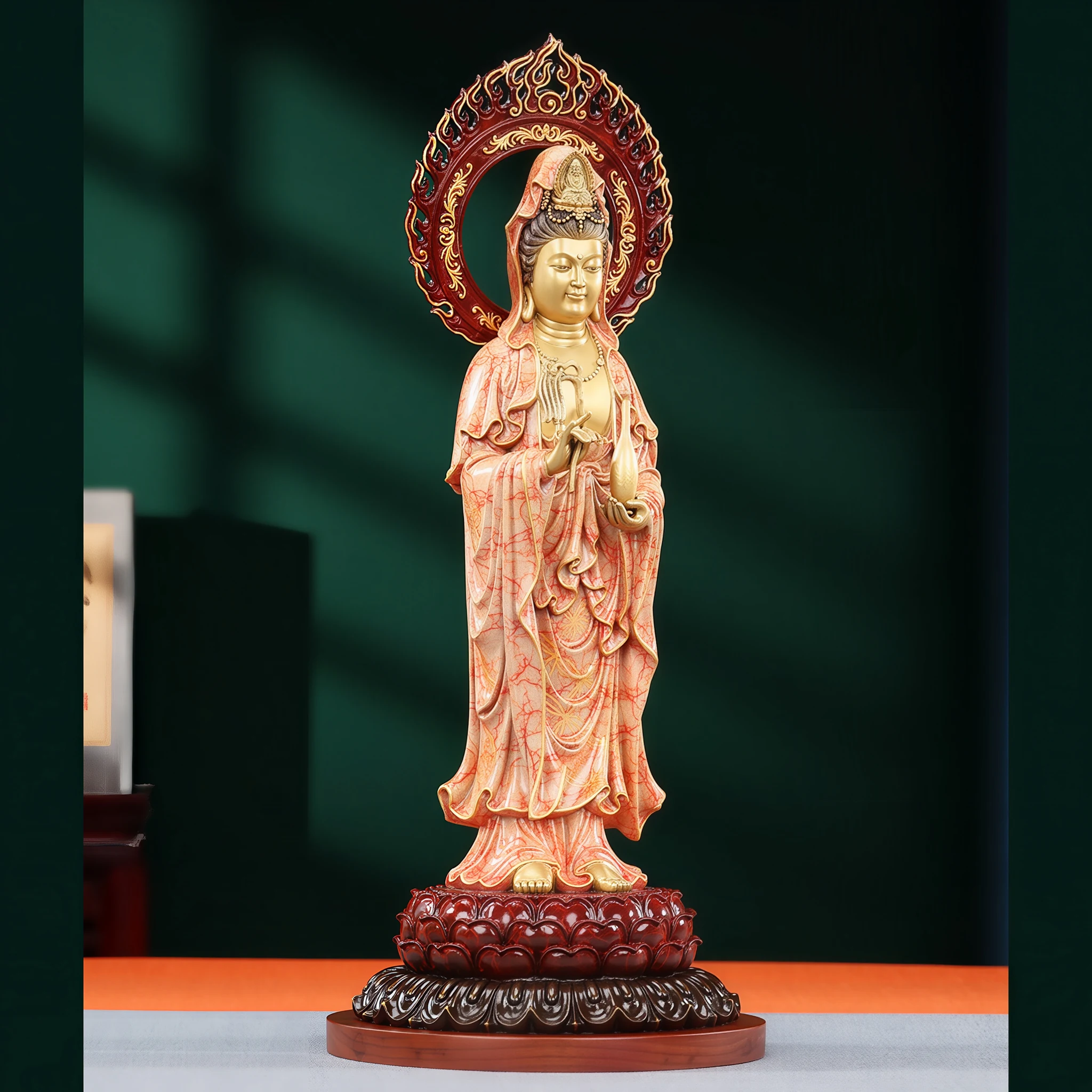 Side view of the coral and gold Yangzhi Guanyin with a flame halo, layered robes and lotus base