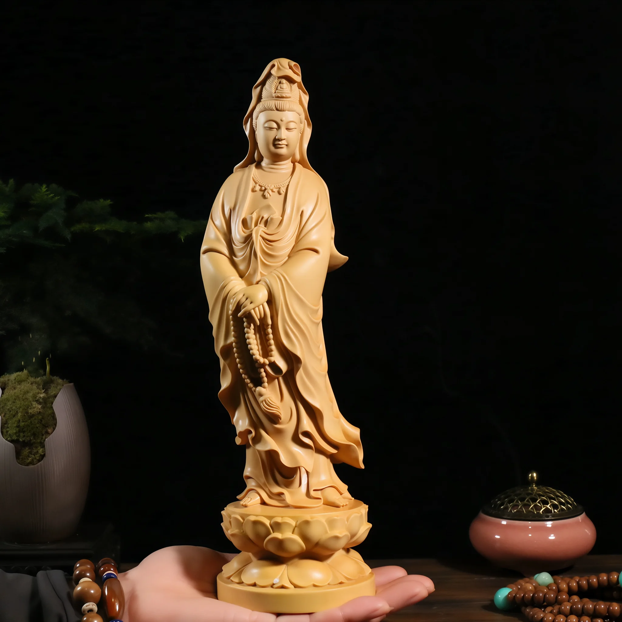 30 cm boxwood Guanyin holding prayer beads, supported on a hand to show its size