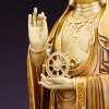 Close view of the Dharma wheel resting above Kuan Yin’s open left palm and the raised right hand