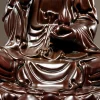 Close-up of Guanyin’s left hand, vase, draped robe and lotus petals