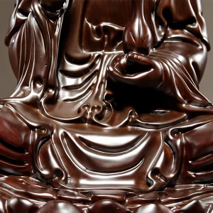 Close-up of Guanyin’s left hand, vase, draped robe and lotus petals