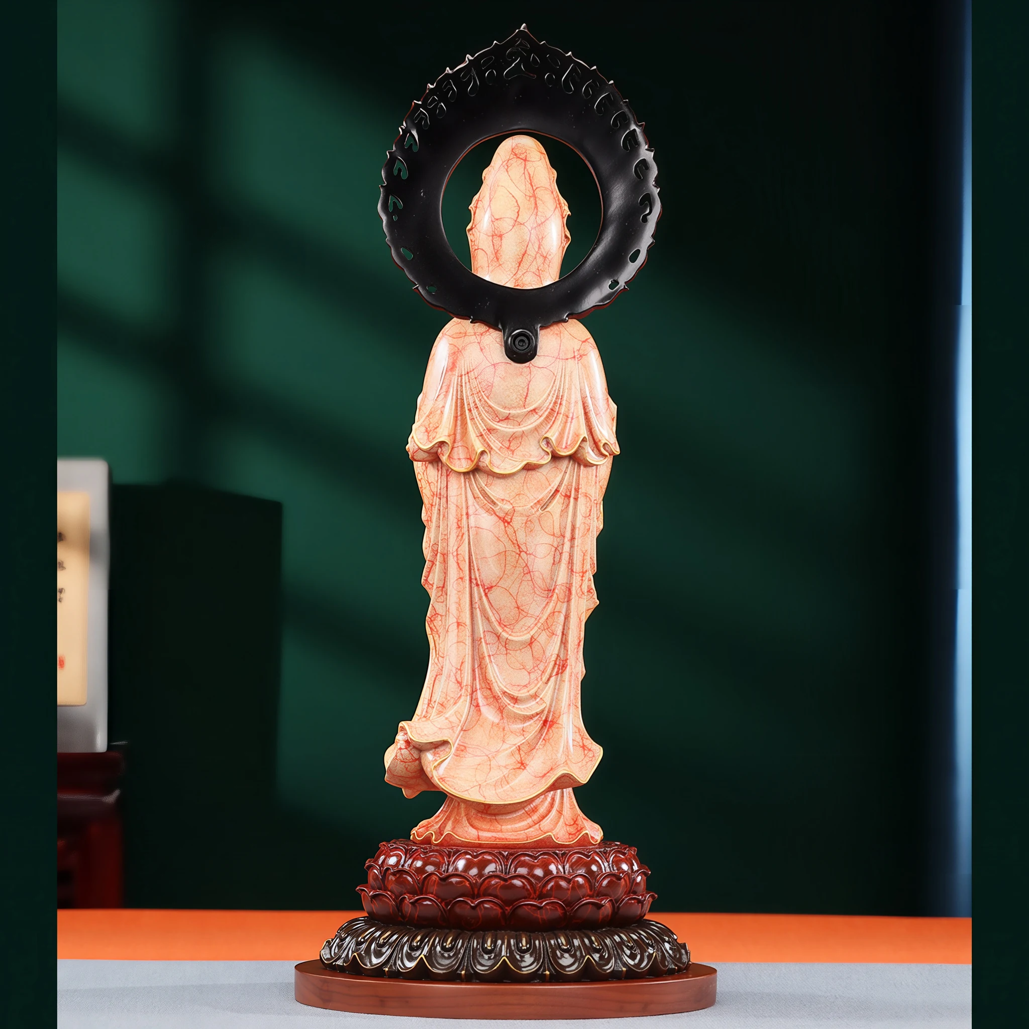 Back of the coral and gold Willow Branch Guanyin, showing the patterned robe and dark halo reverse