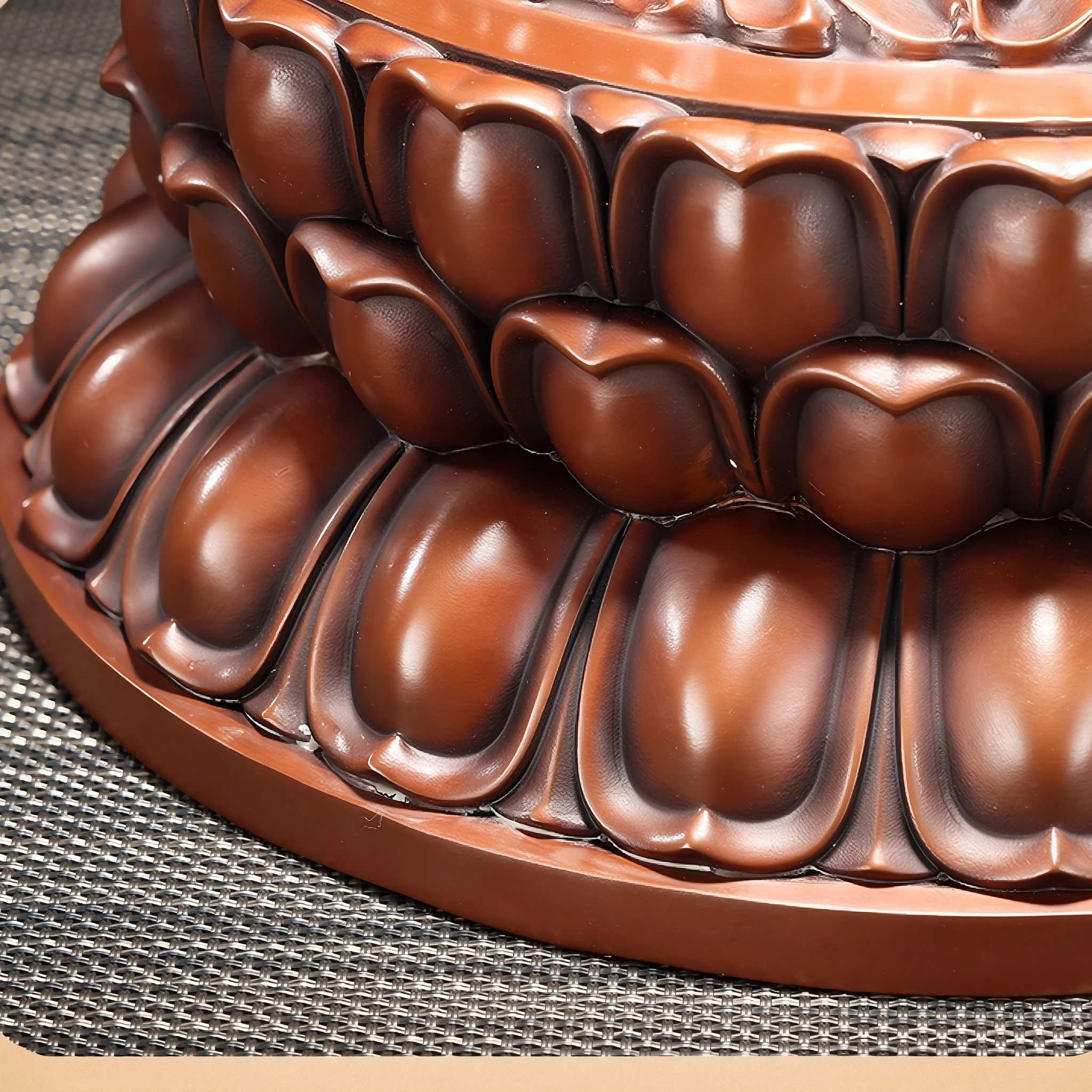 Rounded copper lotus petals with darker recesses on the seated Guanyin pedestal