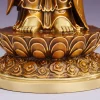 Bare feet, layered lotus petals and swirling relief on the antique tea-gold Guanyin pedestal
