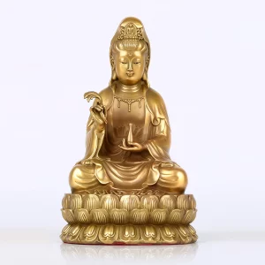 The 12 cm brass Nanhai Guanyin with a rounded face, small willow sprig and vase on a compact lotus base