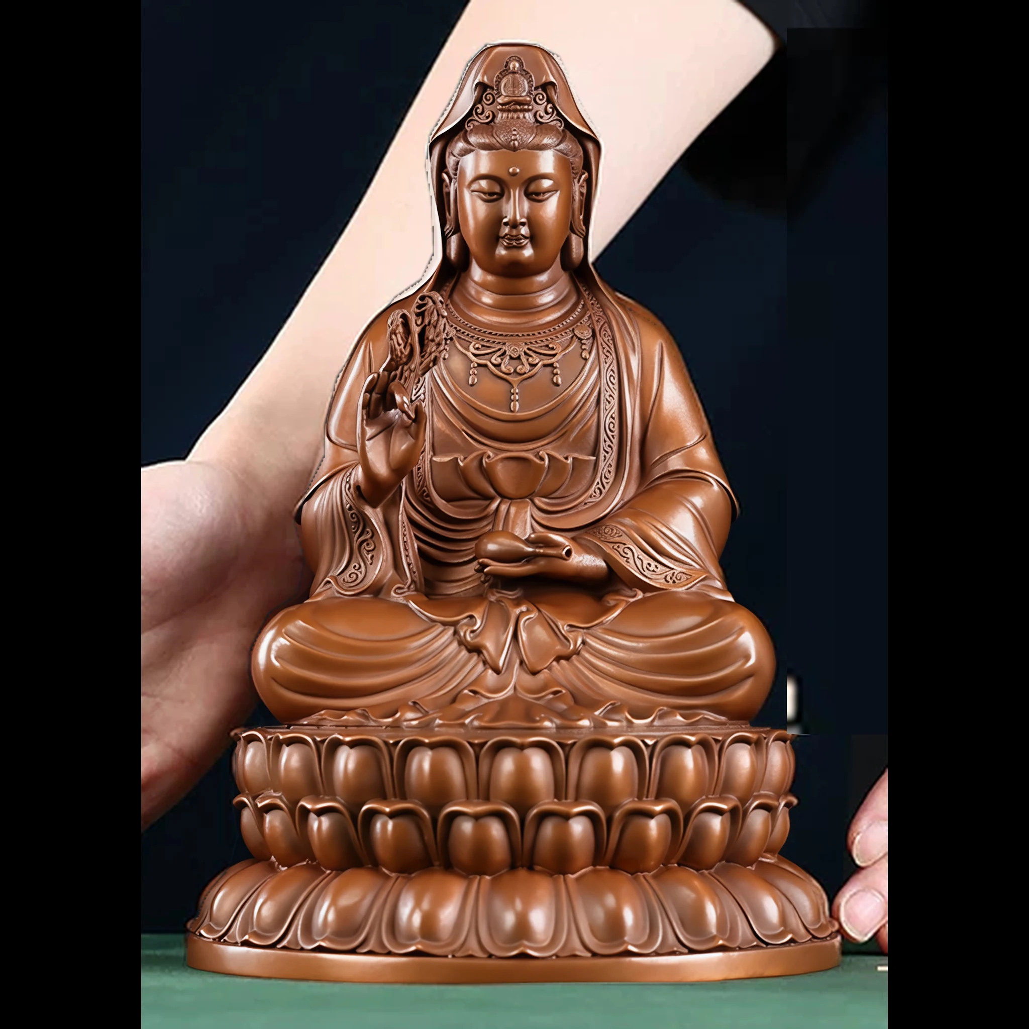 The 22.5 cm copper Willow Guanyin with its compact layered lotus pedestal; the original person provides a visual scale reference