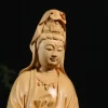 Close view of the boxwood Guanyin’s lowered eyes, veiled crown and carved necklace
