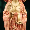 Kuan Yin’s hands holding a slender water vase and willow sprig against coral-patterned robes