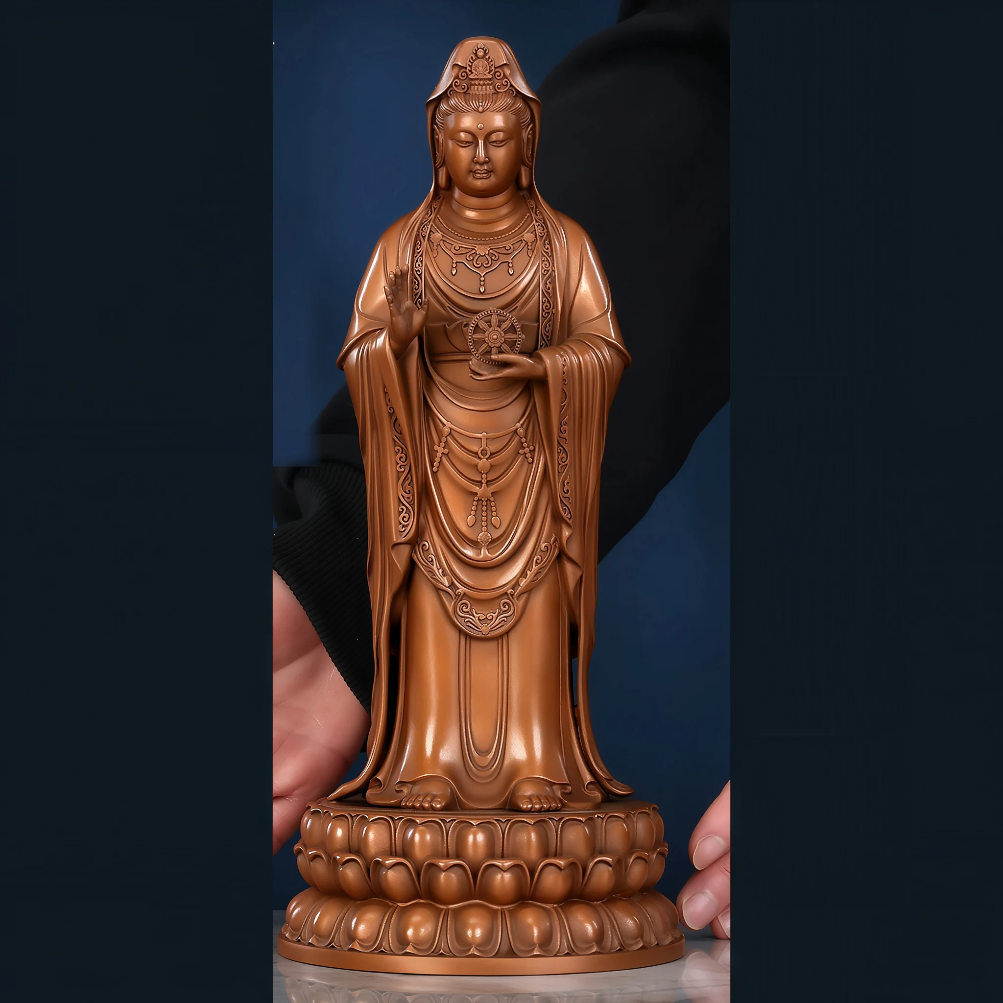 Front view of the 28 cm copper Putuo Guanyin with scrolling garment borders and a Dharma wheel