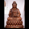 Front view of the 27.7 cm seated copper Guanyin with a willow sprig and tilted vase; the original person provides a visual scale reference