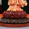 Deep red lotus pedestal, dark lower petals and round display base of the coral and gold Guanyin