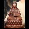Front of the 48.2 cm copper Kuan Yin with its broad, layered lotus pedestal; the original person provides a visual scale reference