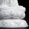 Grooved lotus petals above the raised scroll decoration and octagonal base of Bajiaozuo Guanyin