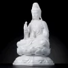 Left-facing view of the white Bajiaozuo Guanyin with raised hand, flowing robes and octagonal base