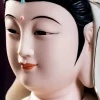 Painted eyes, brows and lips of the White & Blue Baolian Guanyin statue
