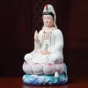 Angled view of a Baolian Kuan Yin statue with white robes, pink-tipped lotus petals and a blue wave base